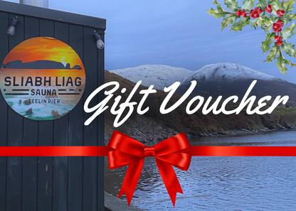 Sliabh Liag Sauna Gift Voucher cover design featuring the bespoke wood-fired sauna at Teelin Pier with snowy mountains, festive holly, and a red ribbon.