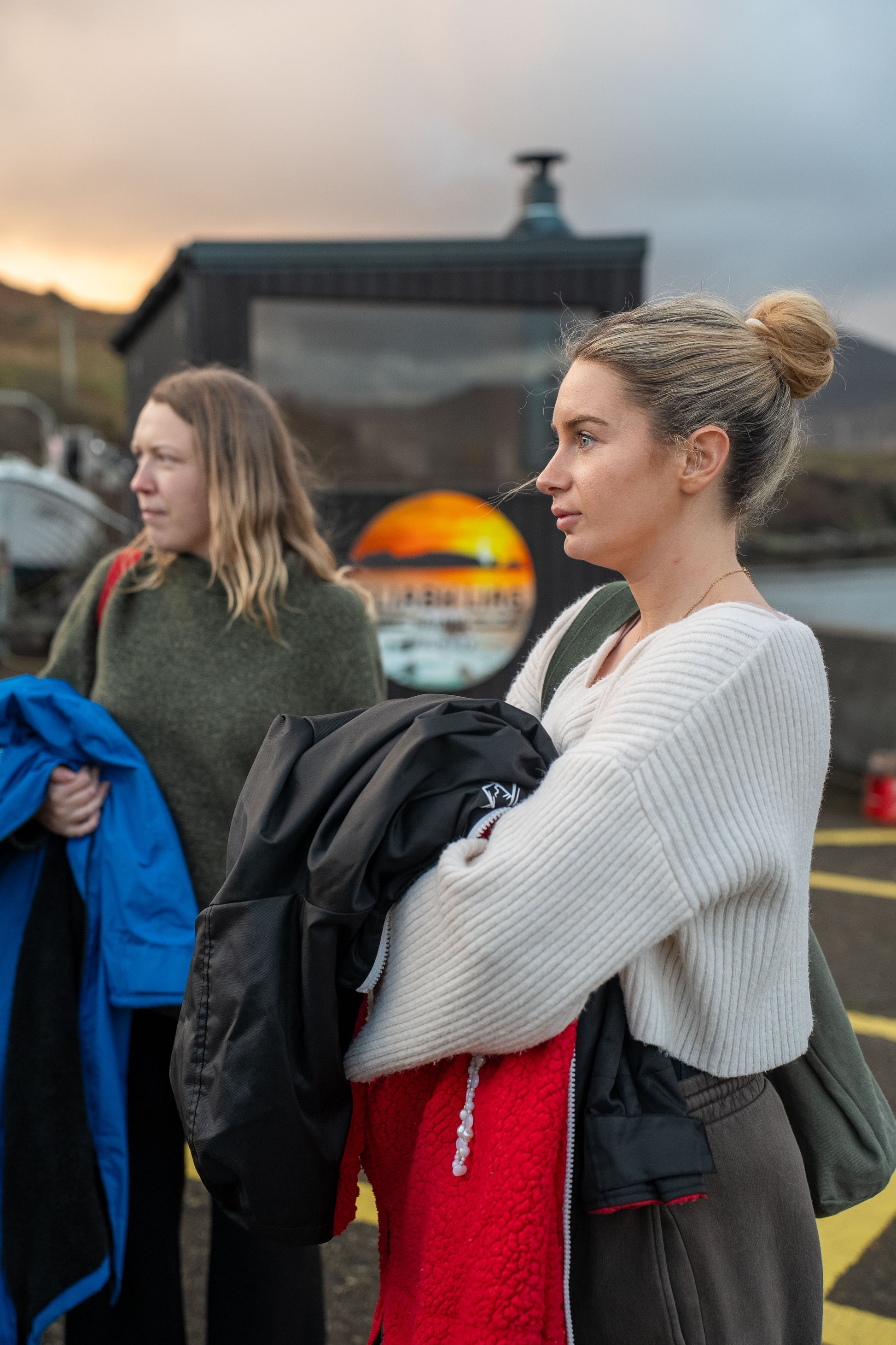 Two guests preparing for a session at the bespoke double wood-fired Sliabh Liag Sauna at Teelin Pier.