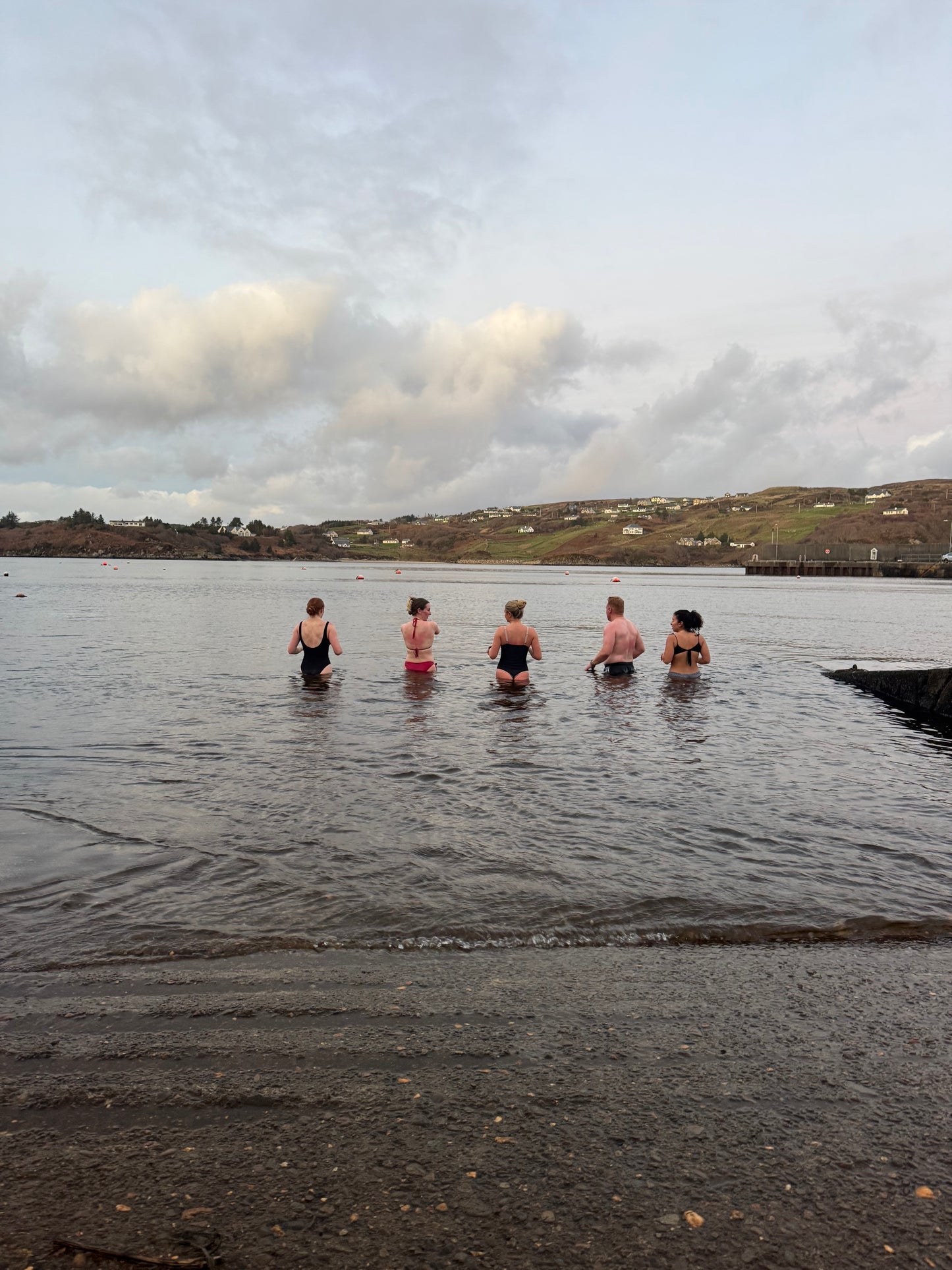 Group of guests taking a sea dip in Teelin Bay after their session in the bespoke double wood-fired Sliabh Liag Sauna.